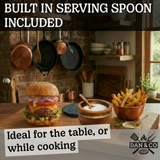 Kitchen scene with burger, fries, wooden salt bowl with serving spoon, rustic cookware backdrop