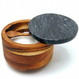 Wooden salt cellar with marble lid and small wooden spoon, filled with salt