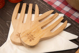 Bamboo wooden salad servers set on napkins, eco-friendly kitchenware on rustic table.