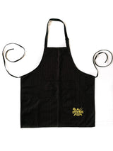 Black pinstripe kitchen apron with front pocket and yellow cooking logo on white background