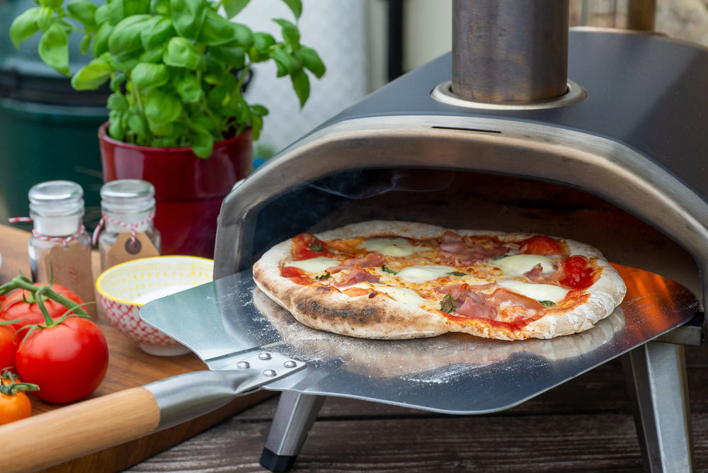 Pizza peel used with an outdoor pizza oven