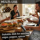 Group enjoying meal with bamboo spice dish, burgers, and wine on wooden dining table