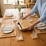 Bamboo placemats and coasters set on a dining table with sustainable kitchenware.