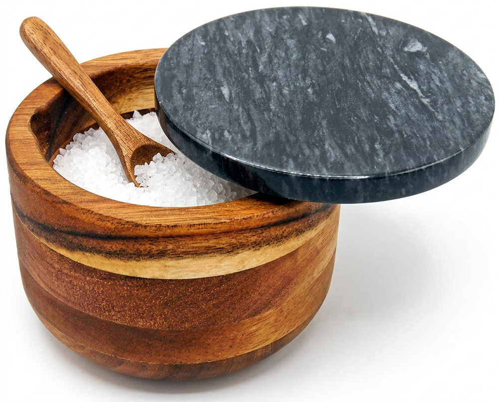 Wooden salt cellar with marble lid and wooden spoon, filled with coarse sea salt