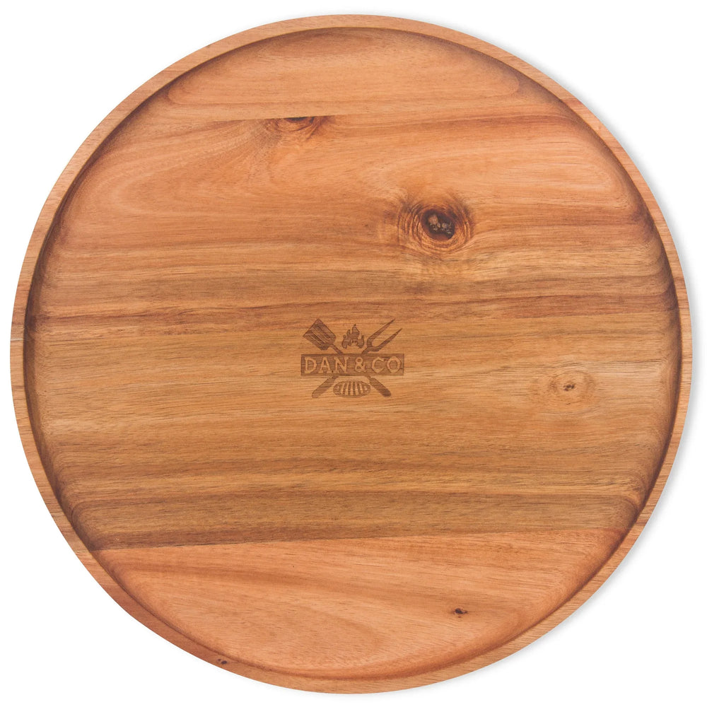 Round acacia wooden serving tray with natural wood grain and engraved center design